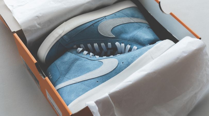 packing shoes into shoe box for moving house