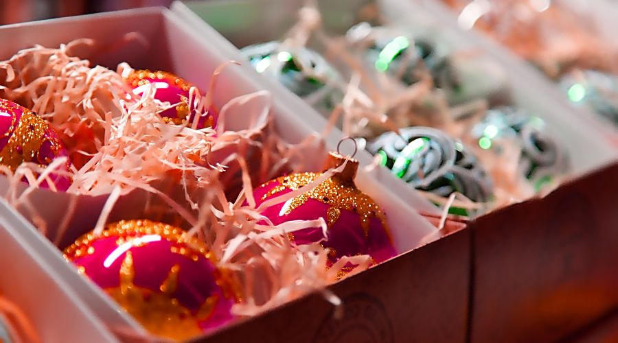 A set of baubles in stored in cardboard boxes, which shows how to store Christmas decorations properly. 