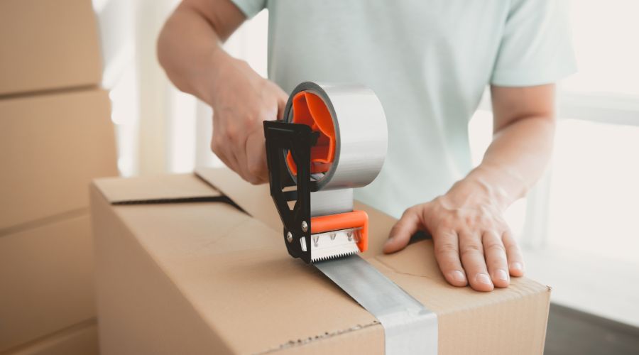 Person packing up a keyboard for moving