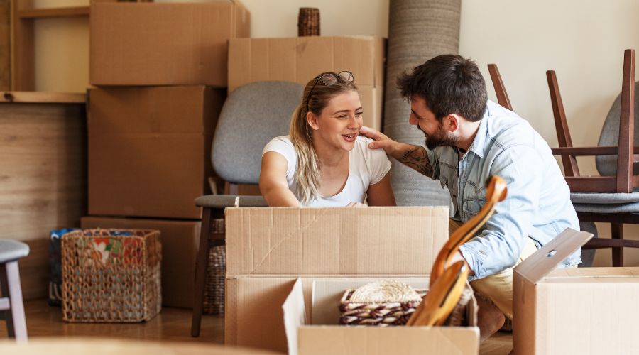 A couple deciding what not to pack when moving.