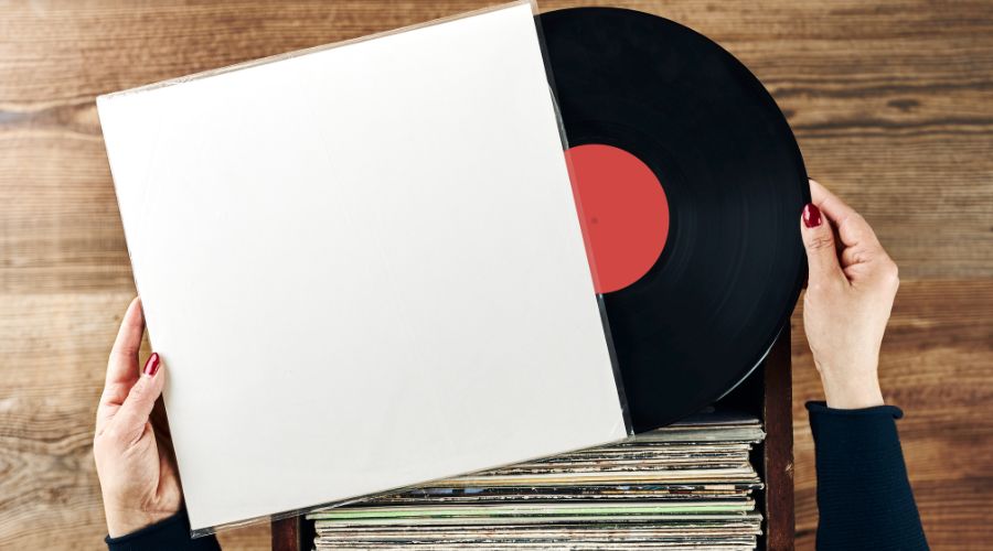 Woman cleaning her vinyl record to properly store it