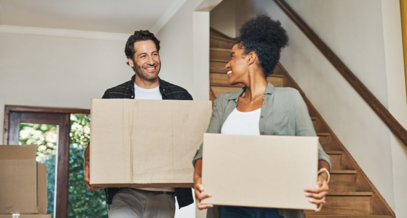 A couple moving furniture safely into storage.